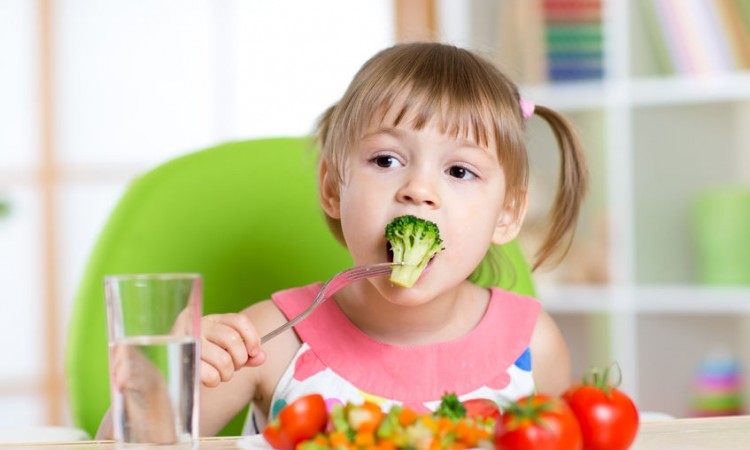 44248780 - child little girl eats vegetable salad using fork