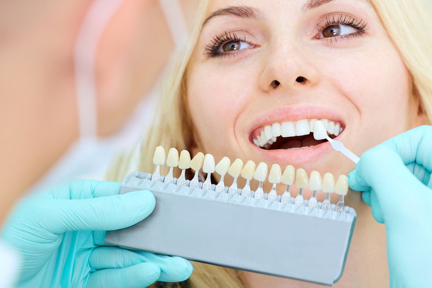 Closeup of a girl with a beautiful smile at the dentist.  Dental care concept